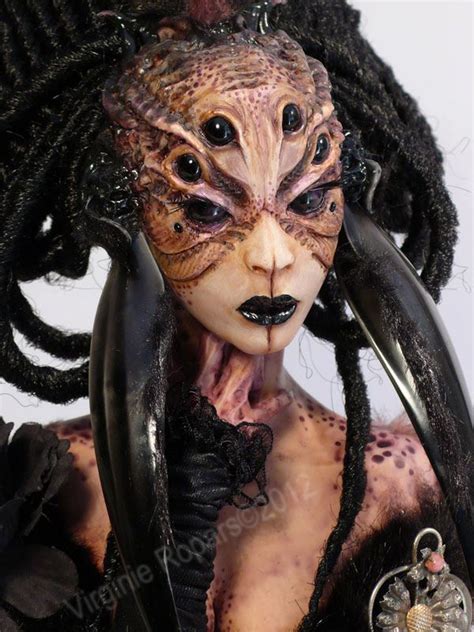 an alien woman with long black hair and dreadlocks