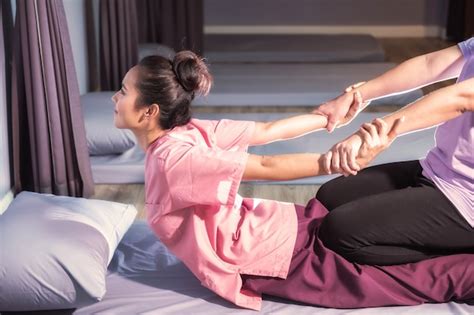 Premium Photo Stretching Back And Hands By Thai Massage