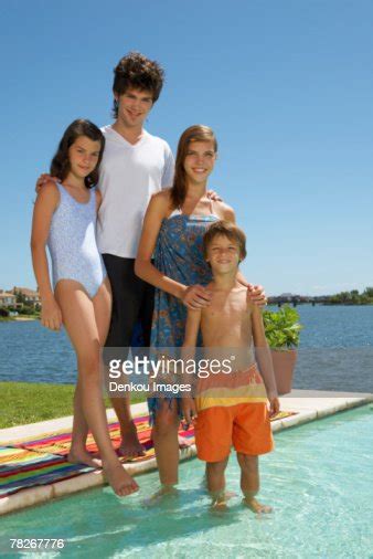 siblings standing by the pool photo getty images