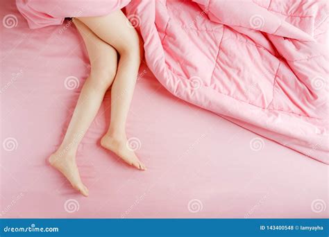 people legs  feet   bed  pink bedclothes top view beautiful