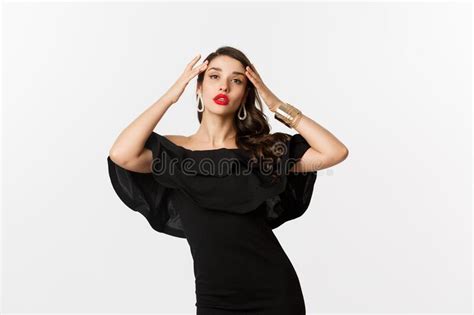 Confident And Stylish Woman In Black Elegant Dress Looking Sassy At