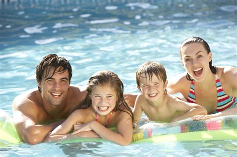 young family relaxing  swimming pool rising sun pools  spas