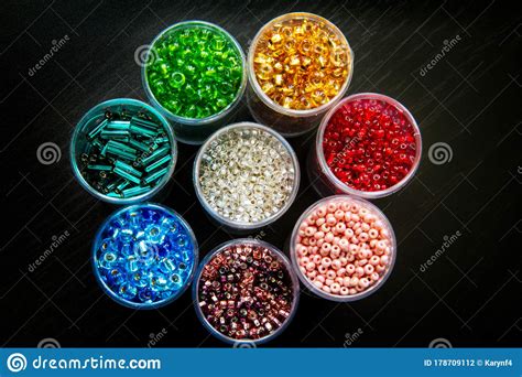 Seed Beads Of Different Sizes In Vials Arranged As A