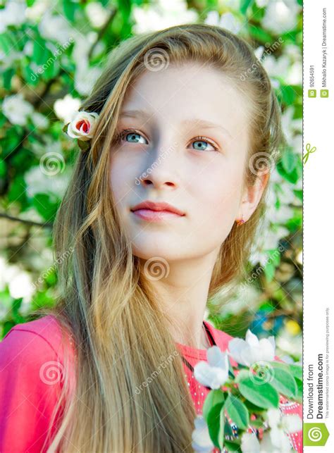 girl on the background of a blossoming tree stock image