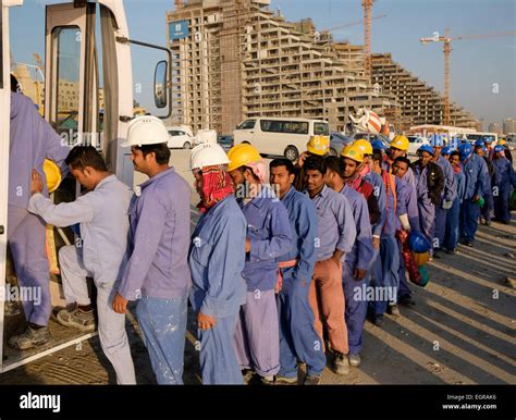 construction workers queuing    bus  living quarters    working day  dubai