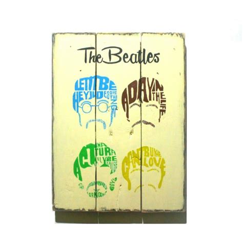 wooden sign   beatles painted   sides  words