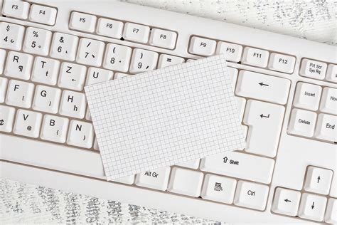 rectangle shaped note colored paper   keyboard   white wooden