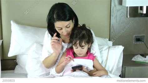 mother teaching her little daughter to play in the stock