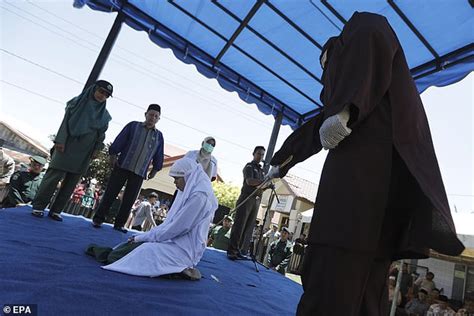 indonesian woman is caned in public for having sex outside of marriage daily mail online