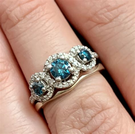 Blue Diamond Three Stone Halo Engagement Ring With Shadow