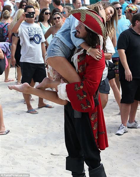 john can t resist kissing wife chrissy teigen who wears skintight pink skirt for moet party