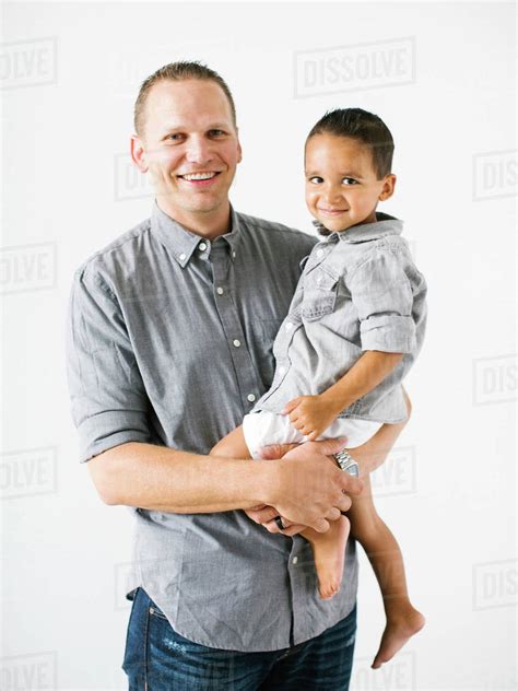 father holding son   stock photo dissolve