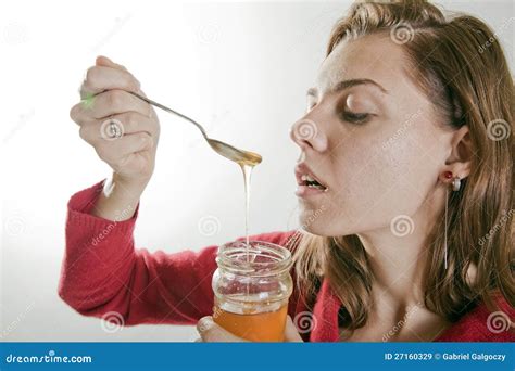 young woman eating honey stock image image  happy