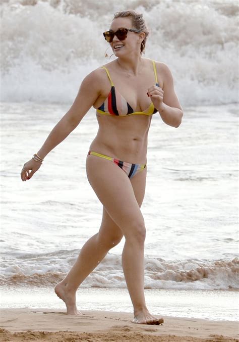 hilary duff wearing a solid and striped bikini popsugar fashion