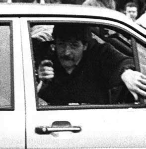 black  white photograph  man sitting  car   people