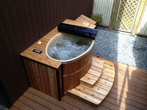 small oval cedar hot tub finished    cedar decking  tub   oval cedar hot