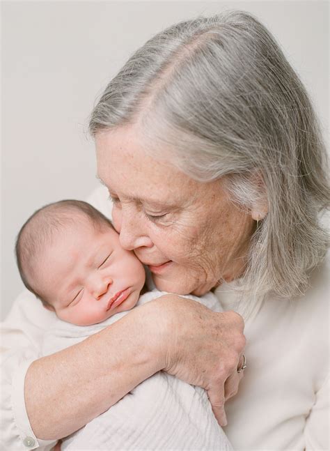 grandma holding newborn baby   studio seattle family film