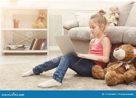 cute  girl  homework  laptop sitting   floor  home