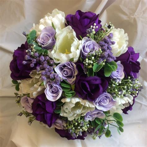 a bridal bouquet of purple lilac and ivory silk roses and tulips purple