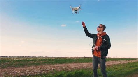 quadrocopter drone flies  guy lands stock footage video  royalty