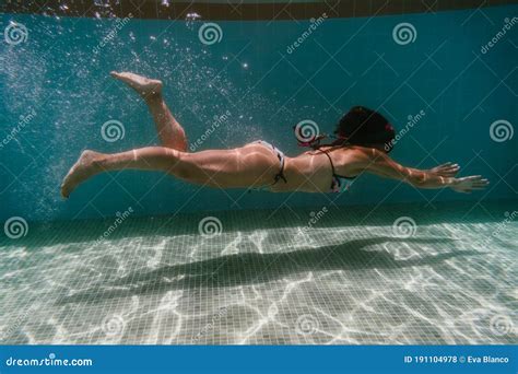 Young Woman Diving Underwater In A Pool Summer And Fun Lifestyle Stock