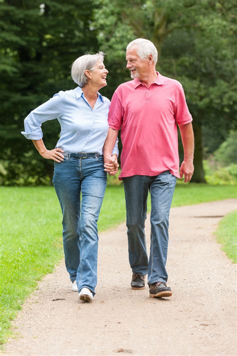 active  happy senior couple walking   park guerradentalcom