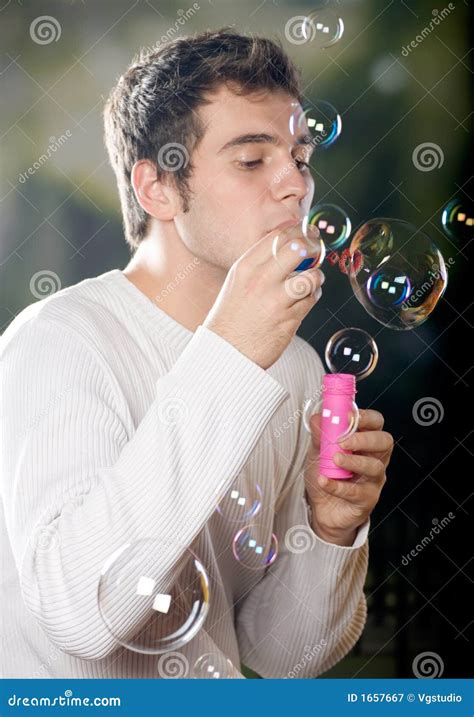 young man blowing bubbles stock image image  young