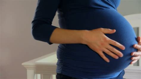 Closeup Of Pregnant Mother Rubbing Her Belly Stock Footage