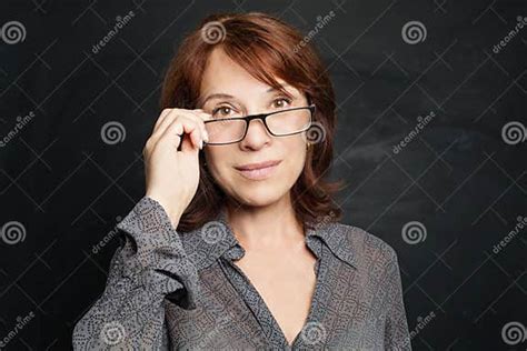 Mature Woman In Glasses Portrait On Black Background Stock Image