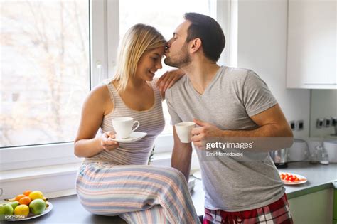 Romantic Couple Drinking Coffee And Flirting In The Kitchen High Res