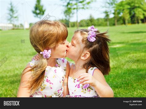 little sisters kissing image and photo free trial bigstock