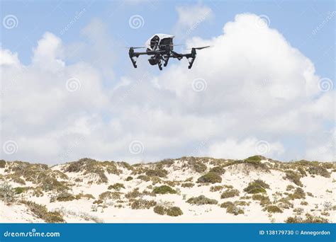 white quadcopter drone  photo camera   dunes editorial image image  point france