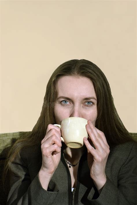 Beautiful Woman Enjoying A Cup Of Freshly Brewed Hot Tea As She Relaxes