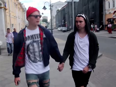 two men hold hands around moscow the reaction they face shows the