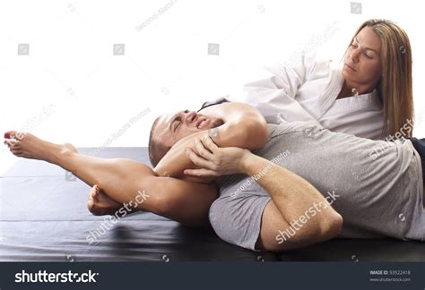 Female Martial Artist Applying A Figure Four Chokehold