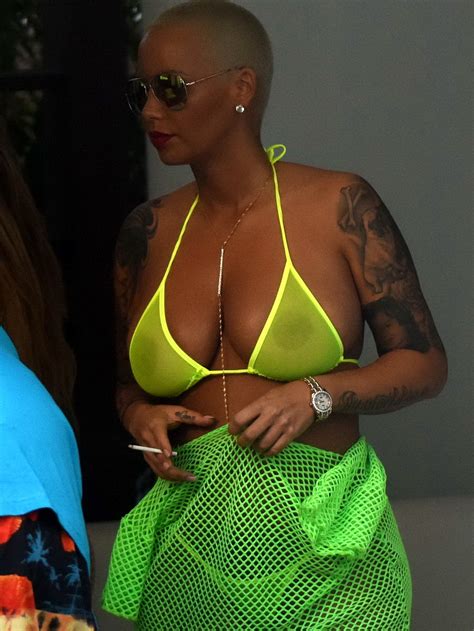 amber rose shows off her big boobs and ass wearing a see through yellow thong bi pichunter