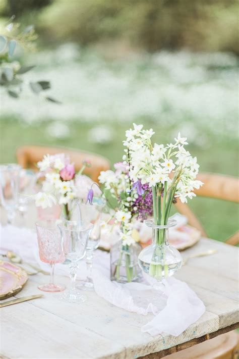 clustered centerpieces  clear vases  white  purple flowers