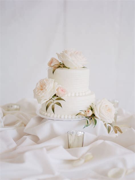Two Tier White Wedding Cake With Lush Roses Wedding Cake Roses