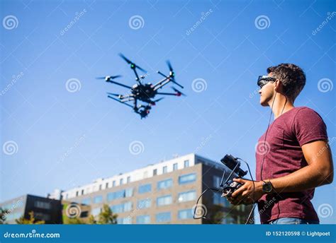 handsome young man flying  drone outdoors stock photo image  aircraft compact
