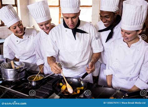 group  chefs preparing food  kitchen stock photo image  adult cooking