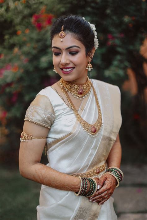 photo of malayali bride in gold jewellery and white saree kerala hindu