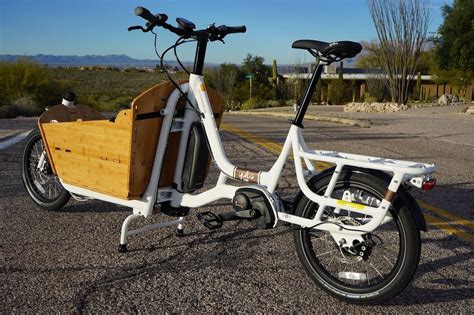 electric bike   wooden basket   front   wheels  parked   parking lot