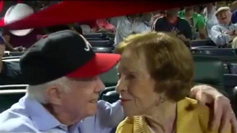 former president jimmy carter smooches his wife on the