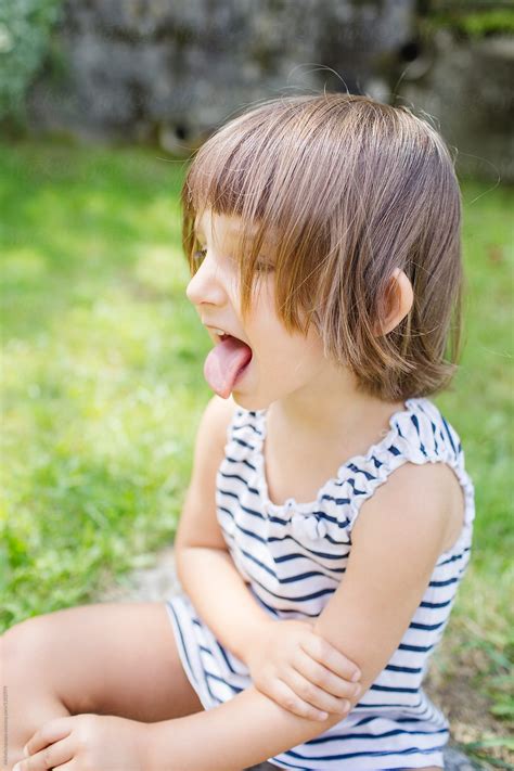 girl sticking tongue   michela ravasio