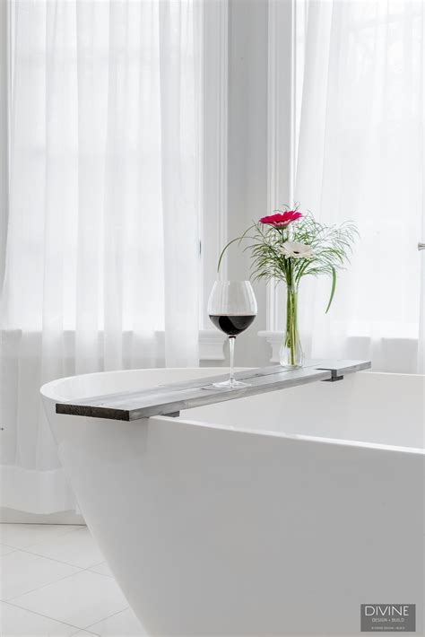 white bath tub sitting    vase   flower  top
