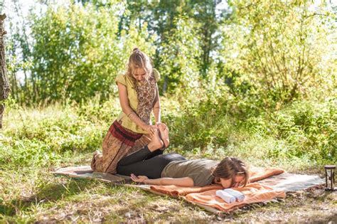 Girl Masseuse Impliments Her Massage Abilities On The Forest Ground