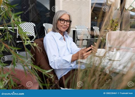 slender well groomed pretty gray haired business woman pensioner spends