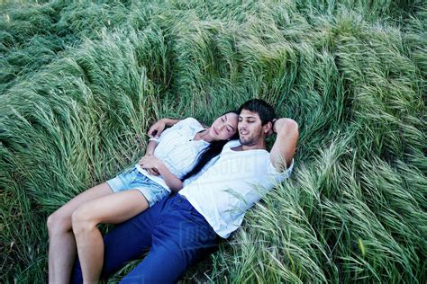 couple laying  grass stock photo dissolve