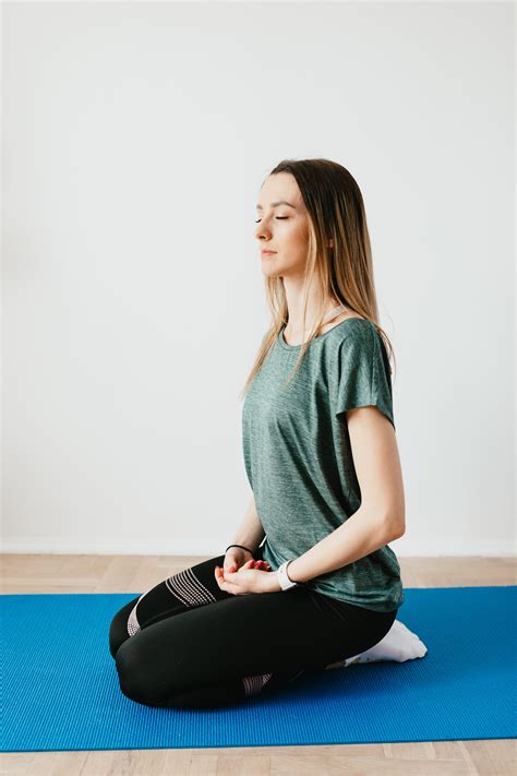 calm woman sitting  hero pose  yoga mat  stock photo