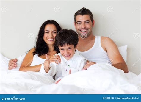 son  thumbs    parents  bed royalty  stock image